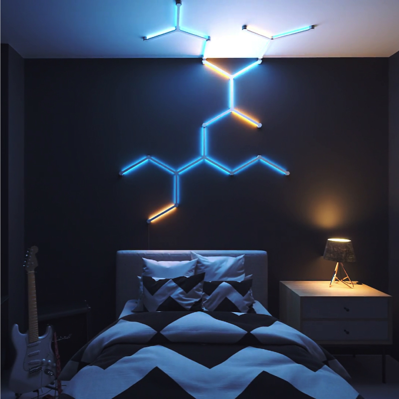 Nanoleaf Lines Thread enabled color changing smart modular backlit light lines flex connectors mounted to a wall in a bedroom. 3 pack. HomeKit, Google Assistant, Amazon Alexa, IFTTT.