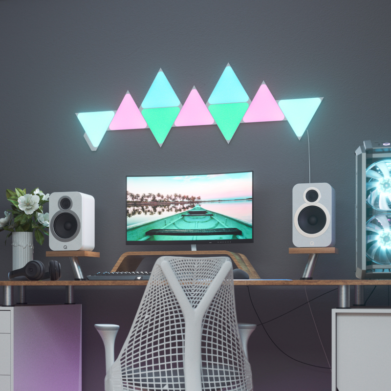 Nanoleaf Shapes Thread enabled color changing triangle smart modular light panels mounted to a wall above a battlestation. Similar to Philips Hue, Lifx. HomeKit, Google Assistant, Amazon Alexa, IFTTT.